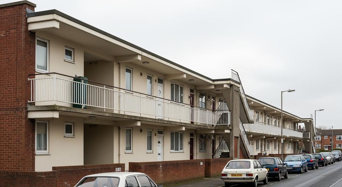 Exterior of a low-rise British social housing block on an overcast day